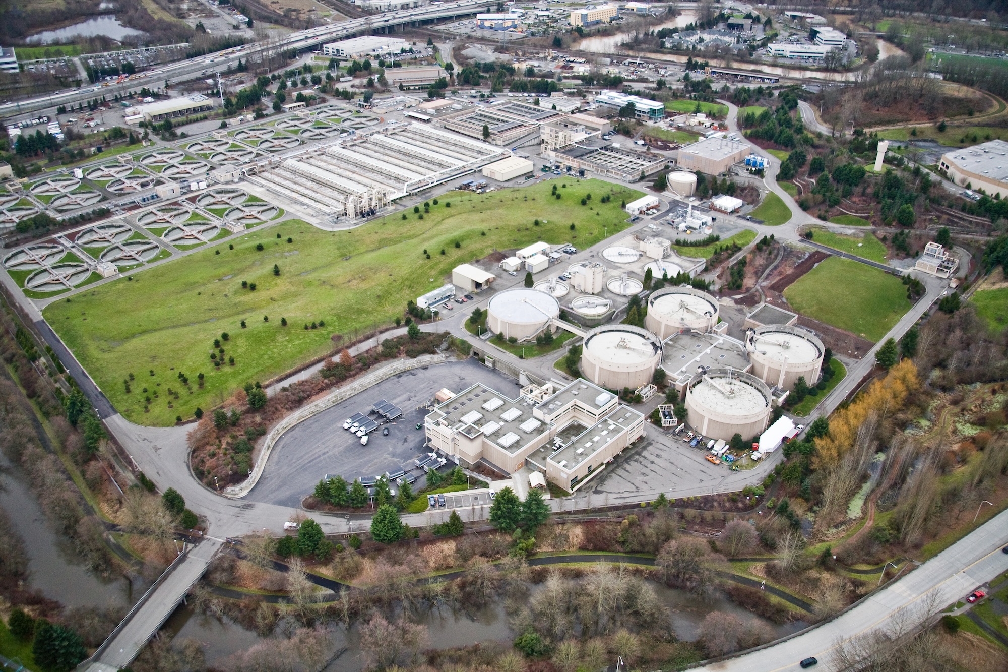 Aerial view of wastewater treatment plant showing buildings and treatment facilities.