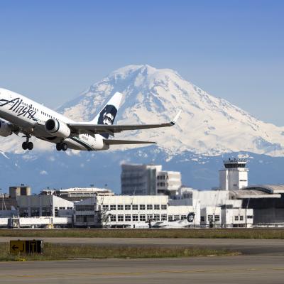 Alaska Airlines 737 taking off from Sea-Tac Airport with Mt Rainier and Central Terminal in background. Photo: Port of Seattle by Don Wilson