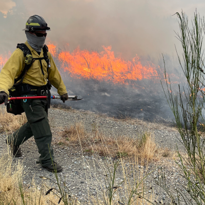 A firefighter monitors a controlled burn near Joint Base Lewis-McChord in Washington. Photo by Jeff Rice.